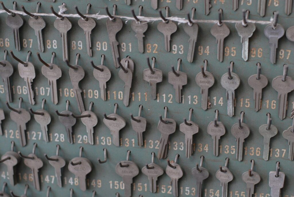 Many numbered keys hanging on a wall board.